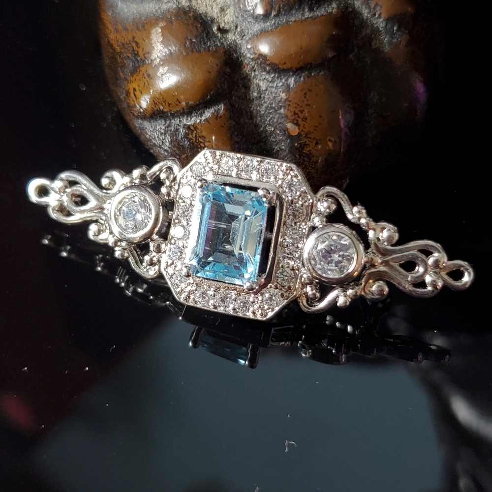 Gold Coast platinum plated brooch pin with blue topaz stone and CZ surround
